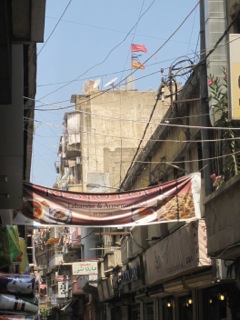 A street scene in Bourj Hammoud. Armenian flags fly on top of the building. Photo: Irina Papkova. 